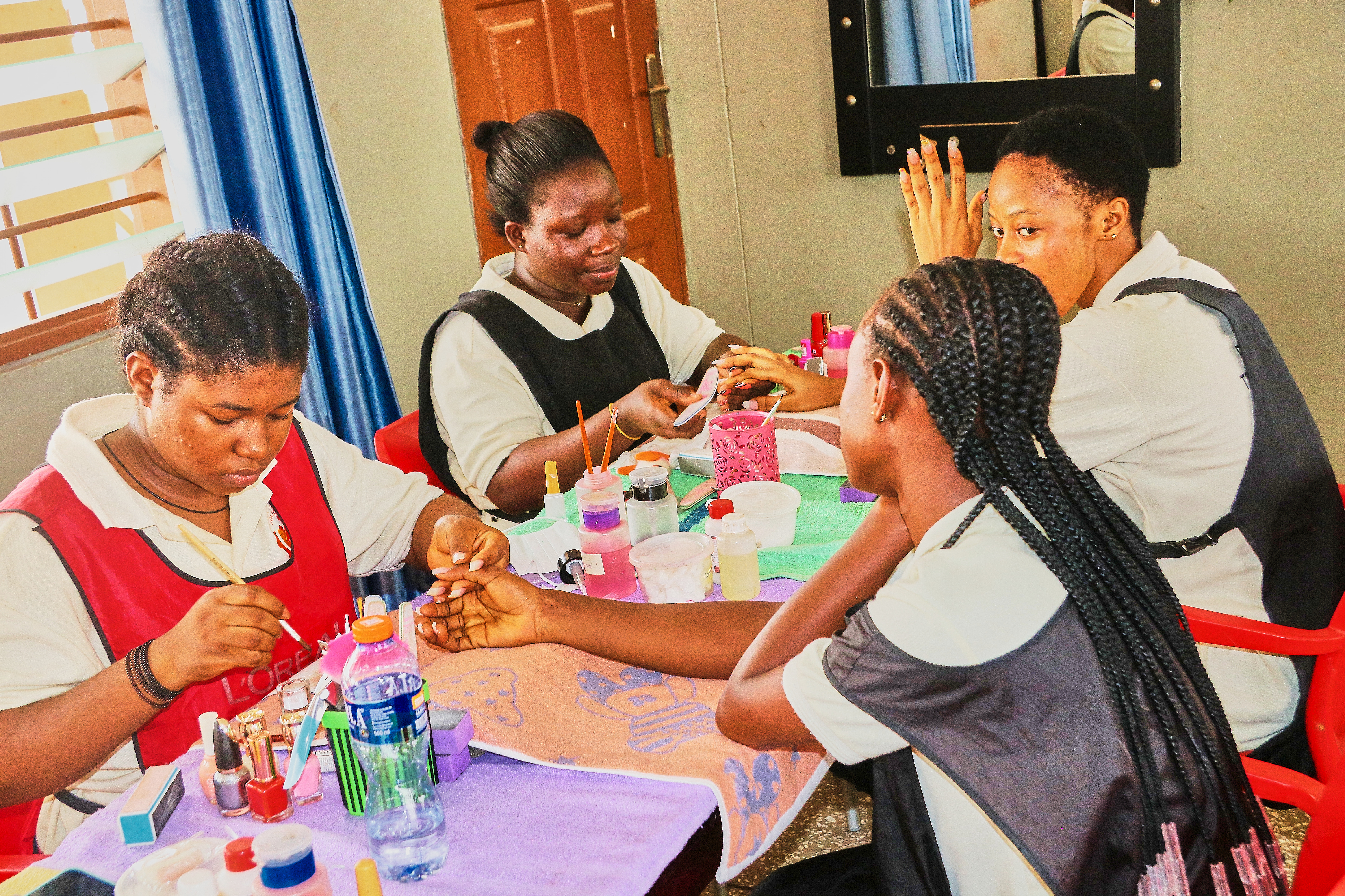 Cosmetology trainee practicing professional nail care and manicure procedures